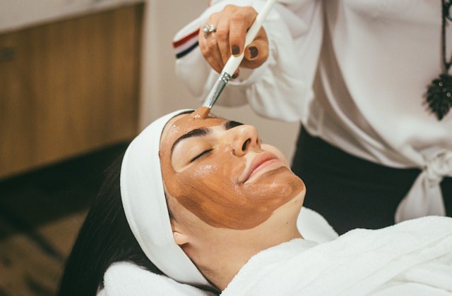 A woman receiving a facial treatment